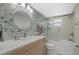 Modern bathroom with hexagonal tile, a glass shower, and updated vanity at 9393 Midnight Pass Rd # 302, Sarasota, FL 34242