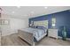 Main bedroom with blue accent wall and ample closet space at 9393 Midnight Pass Rd # 302, Sarasota, FL 34242