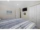 Serene bedroom with a striped comforter and built-in closet at 9393 Midnight Pass Rd # 302, Sarasota, FL 34242