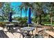 Waterfront deck with patio furniture and umbrellas at 9393 Midnight Pass Rd # 302, Sarasota, FL 34242