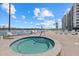 Community hot tub with ample deck space and water views at 9393 Midnight Pass Rd # 302, Sarasota, FL 34242