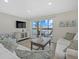 Living room with balcony access and water views at 9393 Midnight Pass Rd # 302, Sarasota, FL 34242