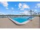 Refreshing community pool with plenty of lounge chairs at 9393 Midnight Pass Rd # 302, Sarasota, FL 34242