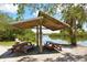 Waterfront pavilion with picnic tables and benches at 9393 Midnight Pass Rd # 302, Sarasota, FL 34242