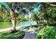 Peaceful waterfront walkway with lush landscaping at 9393 Midnight Pass Rd # 302, Sarasota, FL 34242