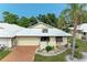 An aerial view of a charming villa with a brick driveway and lush landscaping at 96 Drifting Sands Dr, Venice, FL 34293