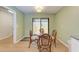 Small dining area with glass table and wicker chairs, near kitchen at 96 Drifting Sands Dr, Venice, FL 34293