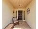 Inviting entryway with a wicker chair and tiled floor at 96 Drifting Sands Dr, Venice, FL 34293