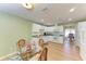 Open concept kitchen and dining area with white cabinets and light floors at 96 Drifting Sands Dr, Venice, FL 34293