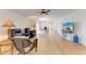 Bright living area with hardwood floors, comfortable seating, and a large TV at 96 Drifting Sands Dr, Venice, FL 34293