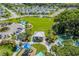 Aerial view of community park with playground, pavilion, and open green space at 10624 Falling Leaf Ct, Parrish, FL 34219