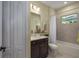 Clean bathroom with a bathtub, vanity, and a window offering natural light at 10624 Falling Leaf Ct, Parrish, FL 34219