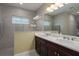 Double vanity bathroom with a large walk-in shower and modern finishes at 10624 Falling Leaf Ct, Parrish, FL 34219