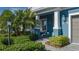 Welcoming entryway with lush landscaping and porch at 10624 Falling Leaf Ct, Parrish, FL 34219