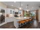 Spacious kitchen featuring white cabinets, island, and hardwood floors at 10624 Falling Leaf Ct, Parrish, FL 34219