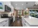 Modern kitchen with stainless steel appliances and white cabinetry at 10624 Falling Leaf Ct, Parrish, FL 34219