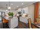 Modern kitchen with white cabinets, quartz countertops, and island seating at 10624 Falling Leaf Ct, Parrish, FL 34219