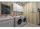 Laundry room with washer, dryer, sink, and upper cabinets at 10624 Falling Leaf Ct, Parrish, FL 34219