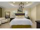 Spacious main bedroom with a king-size bed, high ceilings and elegant decor at 10624 Falling Leaf Ct, Parrish, FL 34219