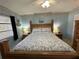 Guest bedroom with a wooden bed frame and coastal-themed decor at 100 The Esplanade N # 6, Venice, FL 34285