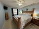 Main bedroom with wooden bed frame and coastal bedding at 100 The Esplanade N # 6, Venice, FL 34285