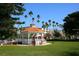 White gazebo with orange roof in a park-like setting at 100 The Esplanade N # 6, Venice, FL 34285