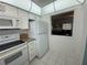 White kitchen with granite countertops and modern appliances at 100 The Esplanade N # 6, Venice, FL 34285