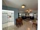 Open living and kitchen area with light blue walls and tile flooring at 100 The Esplanade N # 6, Venice, FL 34285