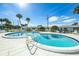 Kidney shaped community pool with surrounding patio at 100 The Esplanade N # 6, Venice, FL 34285