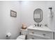 Small half bathroom with white vanity and oval mirror at 1021 99Th Nw St, Bradenton, FL 34209