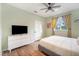 Bedroom with a queen bed, dresser and window with yellow curtains at 1021 99Th Nw St, Bradenton, FL 34209