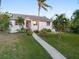 Single-story home with light-colored siding and walkway at 1021 99Th Nw St, Bradenton, FL 34209