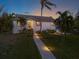 House exterior with a walkway, landscaping, and palm trees at 1021 99Th Nw St, Bradenton, FL 34209