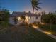 House exterior with walkway, landscaping, and palm trees at dusk at 1021 99Th Nw St, Bradenton, FL 34209