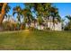 House exterior showcasing a manicured lawn, palm trees, and a walkway at 1021 99Th Nw St, Bradenton, FL 34209