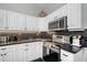 Modern kitchen with stainless steel appliances and white cabinets at 1021 99Th Nw St, Bradenton, FL 34209