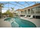 Enclosed pool area with lounge chairs at dusk at 1021 99Th Nw St, Bradenton, FL 34209