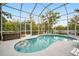 Enclosed kidney shaped pool with lounge chairs and floatie at 1021 99Th Nw St, Bradenton, FL 34209