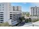 Aerial view of building and parking structure with water and cityscape in background at 111 S Pineapple Ave # 607, Sarasota, FL 34236