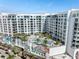 Aerial view of a modern building with a pool and mural at 111 S Pineapple Ave # 607, Sarasota, FL 34236