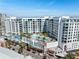 Aerial view of a modern building with a pool and mural at 111 S Pineapple Ave # 607, Sarasota, FL 34236