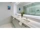 Elegant bathroom with dual sinks and a large mirror at 111 S Pineapple Ave # 607, Sarasota, FL 34236