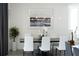 Elegant dining area features a contemporary table with white chairs and pendant lighting at 111 S Pineapple Ave # 607, Sarasota, FL 34236