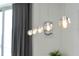 Close up of stylish globe pendant lights above a dining table at 111 S Pineapple Ave # 607, Sarasota, FL 34236