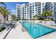 Inviting pool area with surrounding lounge chairs at 111 S Pineapple Ave # 607, Sarasota, FL 34236