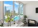 Stunning city view from inside the condo, showcasing a pool and palm trees at 111 S Pineapple Ave # 607, Sarasota, FL 34236