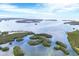 Aerial view of waterfront property with lush landscape and waterways at 115 Burns Rd, Terra Ceia, FL 34250