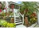 Lush tropical landscaping with gazebo and stairs at 115 Burns Rd, Terra Ceia, FL 34250