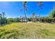 Lush backyard with a private dock, offering direct access to the water for boating and watersport activities, great for outdoor living at 115 Burns Rd, Terra Ceia, FL 34250