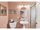 Charming bathroom with a pedestal sink, decorative accents, and a shower with a gold-framed door at 115 Burns Rd, Terra Ceia, FL 34250